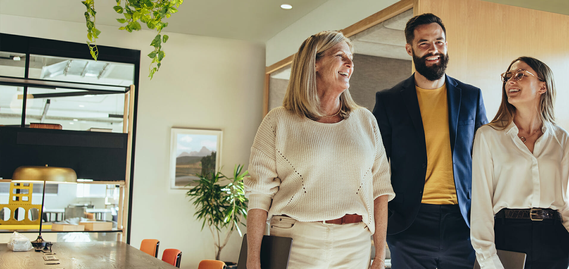 Three people standing together in an office.