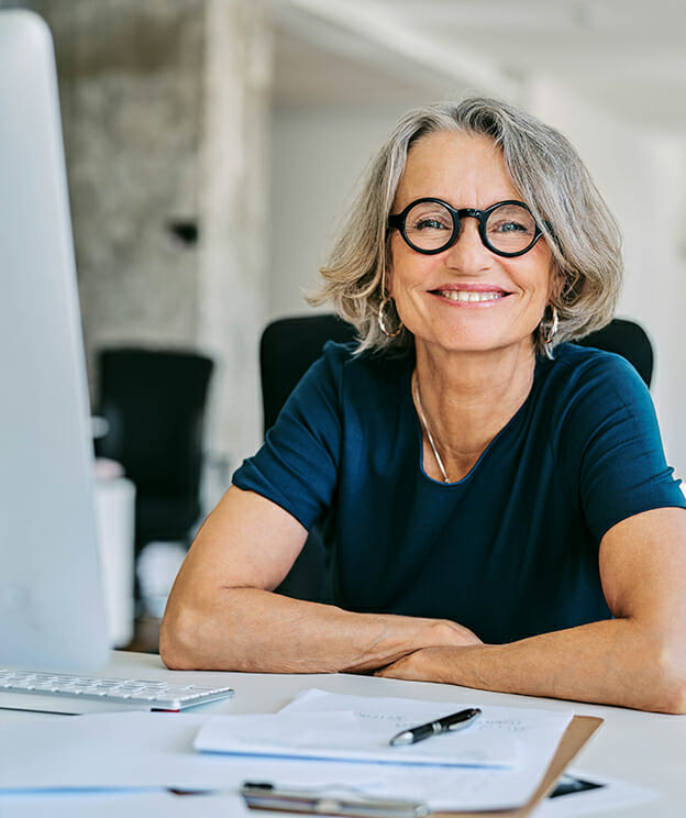 Smiling businesswoman at desk in office