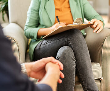 A woman takes notes during the consultation