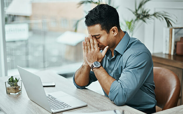 exhausted man at desk