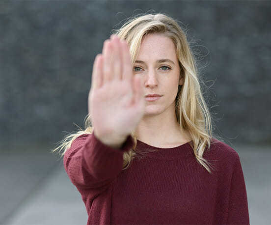 Woman making stop gesture with her raised hand