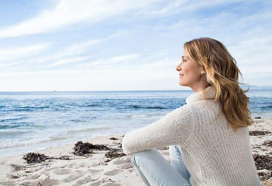 Woman looking relaxed at the sea