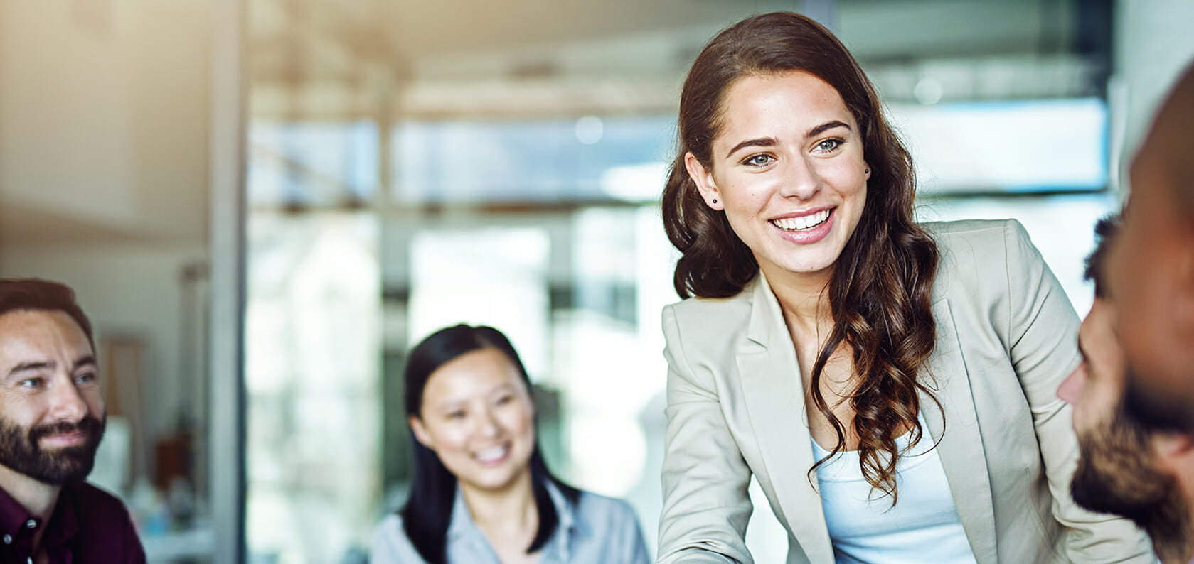 Two cheerful businesspeople shaking hands