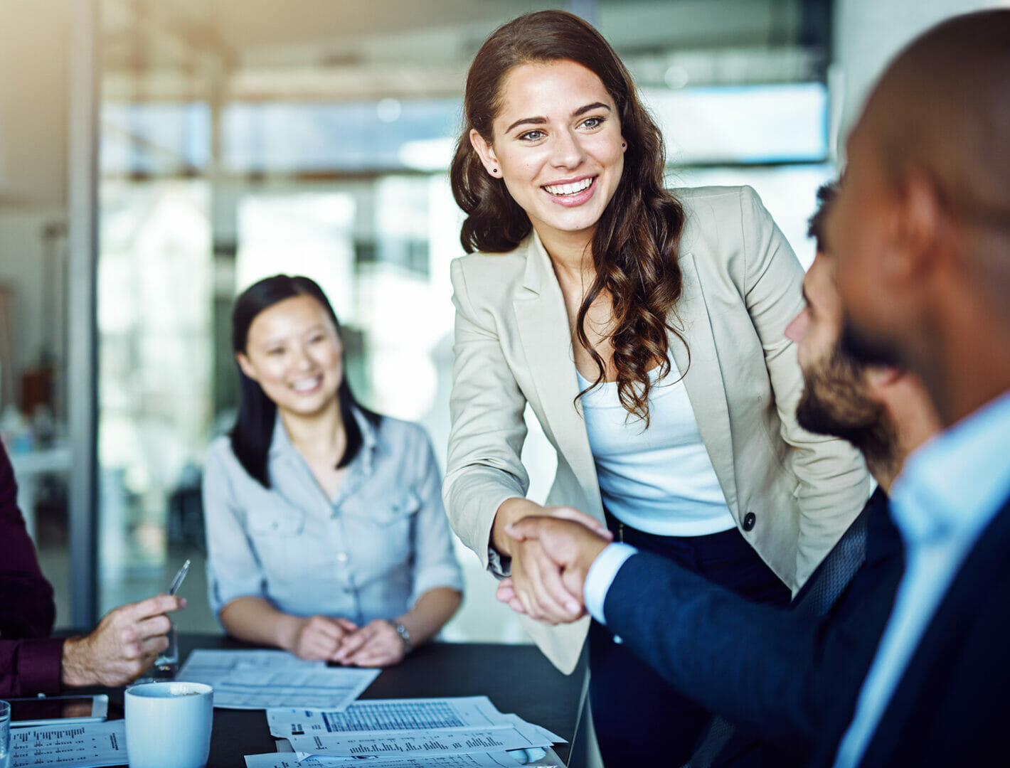 Two cheerful businesspeople shaking hands