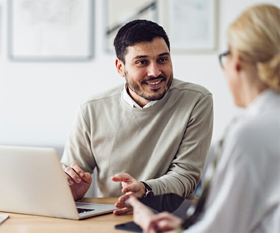 Young man talking to a colleague