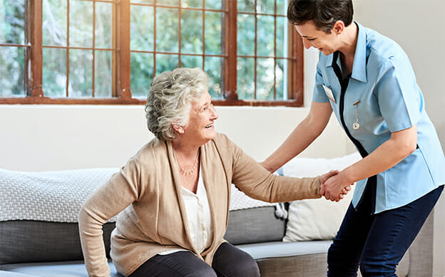 Caregiver helping an older woman