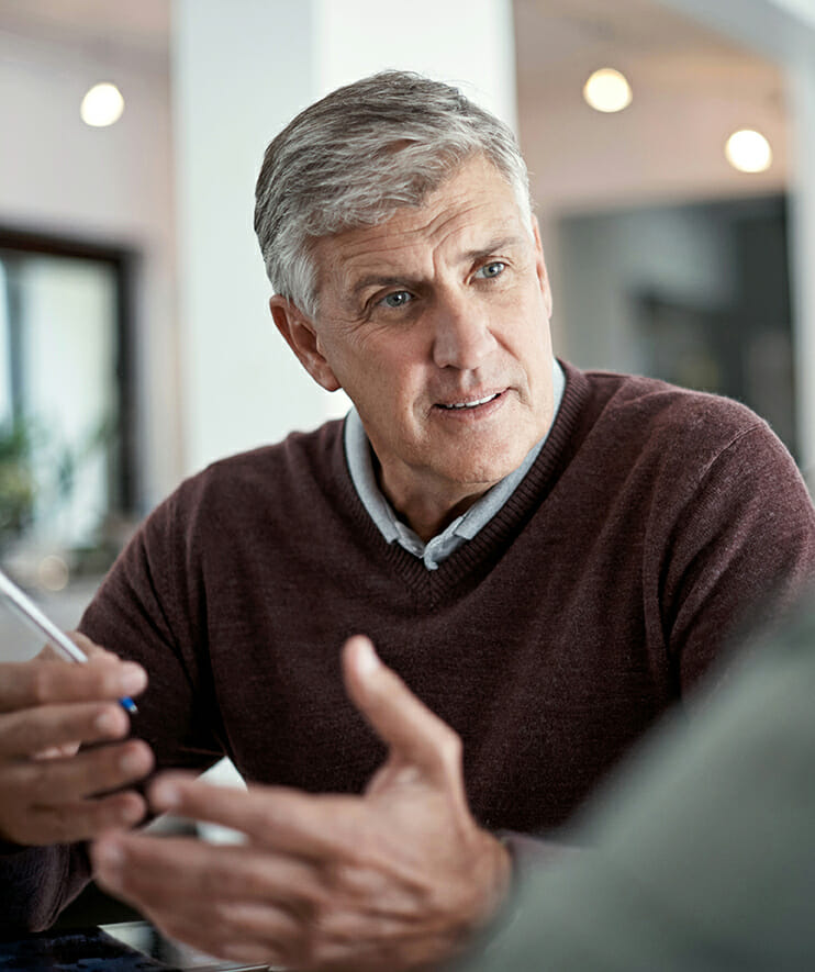 Mature man having a conversation with someone