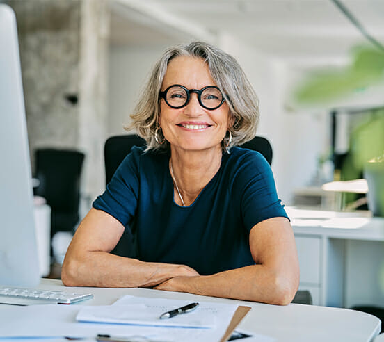 Smiling businesswoman at desk in office