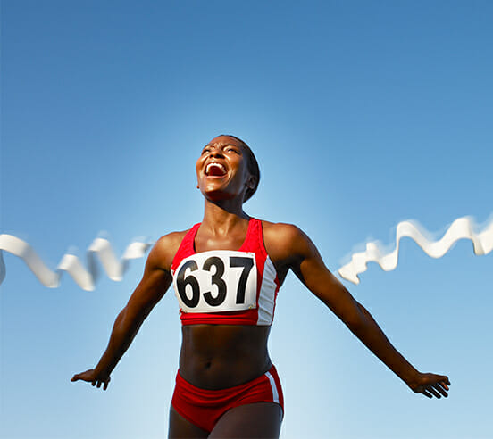 Athlete crossing the finish line smiling