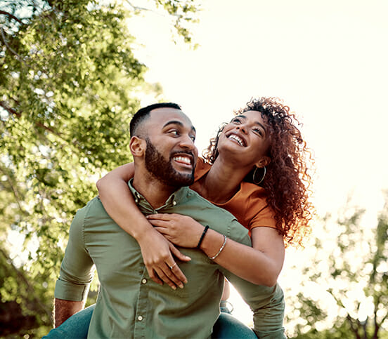 Man giving his girlfriend a piggyback ride