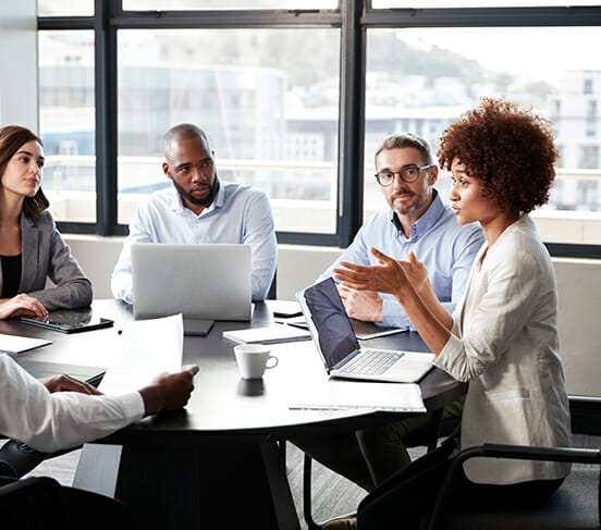 several people sitting in a team meeting